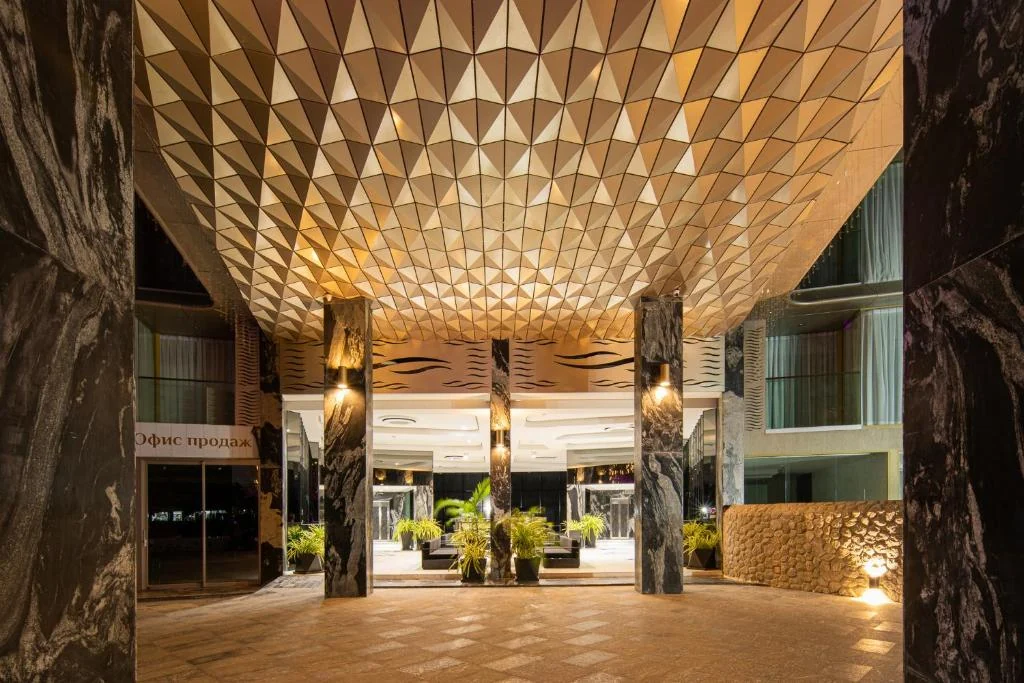 Warmly lit lobby at Andaman Riviera with a patterned timber ceiling